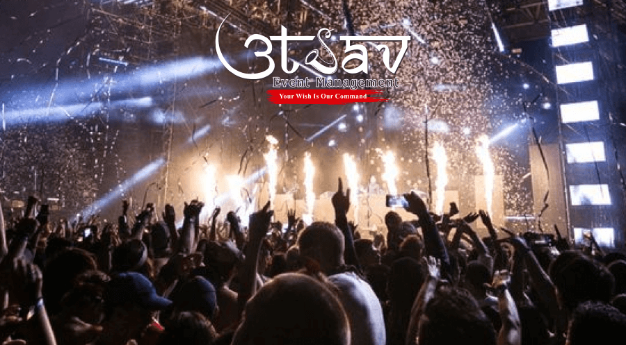 New Year party celebration with fireworks, stage lighting, confetti effects, and crowd managed by professional party planners